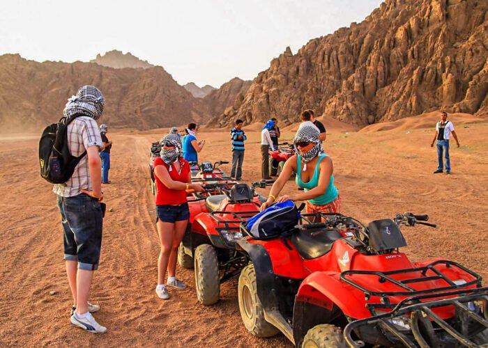 A wonderful shot of a group of people preparing to ride a quad bike from one of the safari trips in Hurghada
