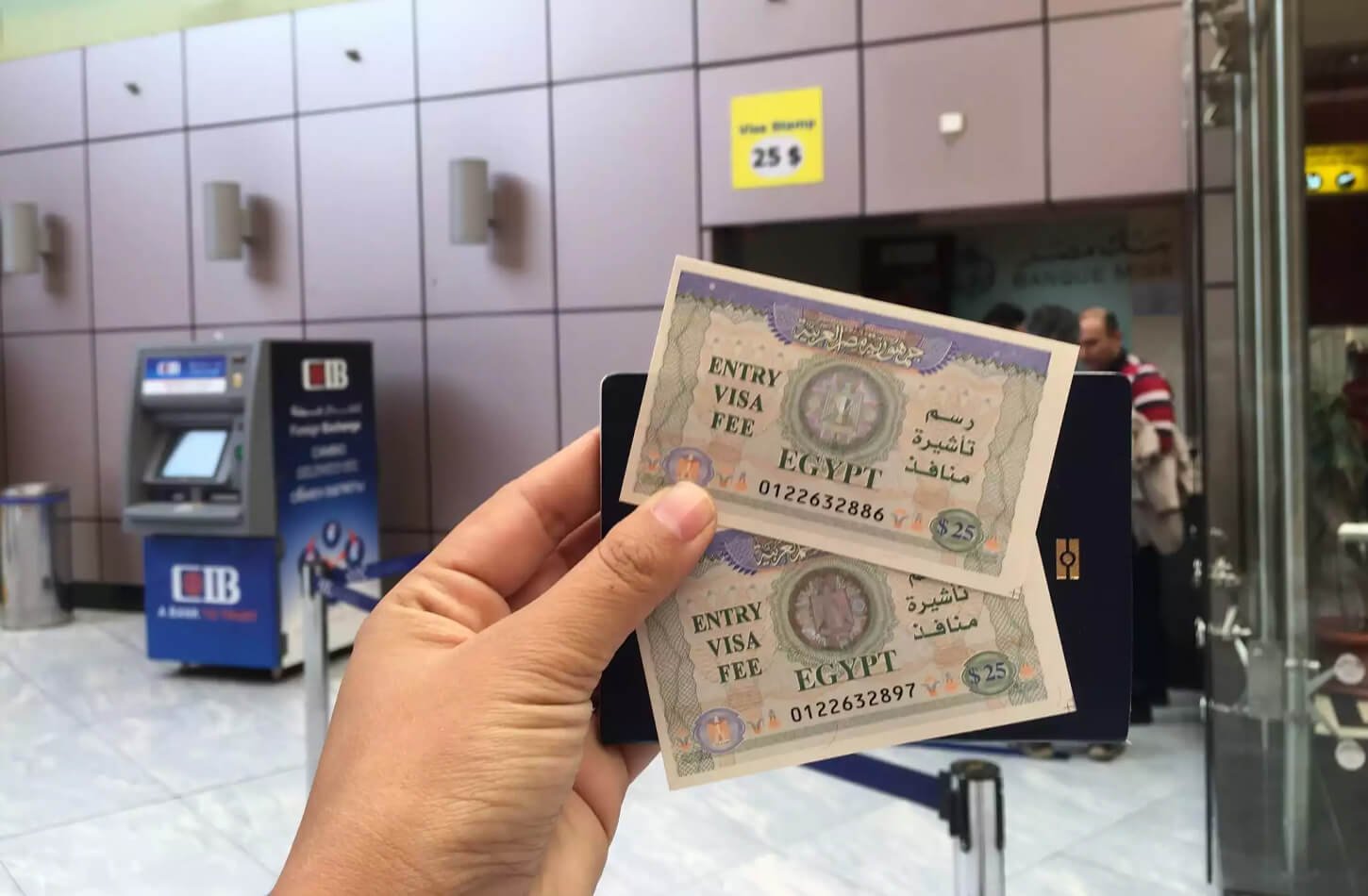 Photo of a person at the airport taking a photo of an Egyptian visa