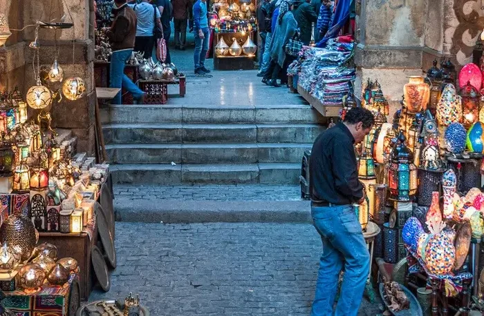 Vibrant stall displaying handmade metal lamps and traditional Egypt souvenirs in Khan el-Khalili bazaar, Cairo