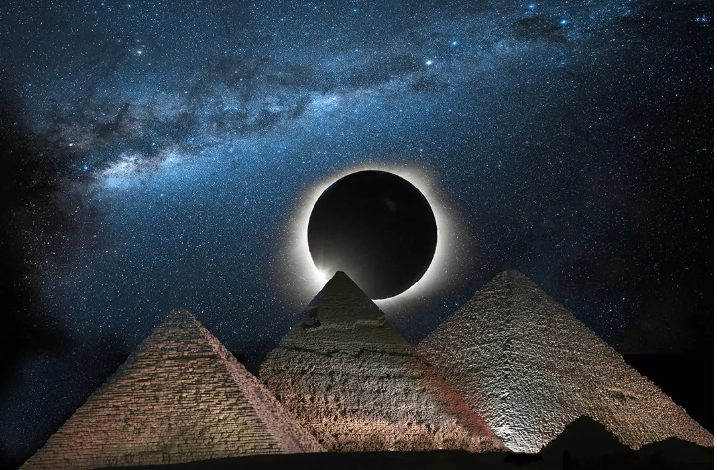 Composite image of a total solar eclipse over the three Great Pyramids of Giza under a starry Milky Way night sky.
