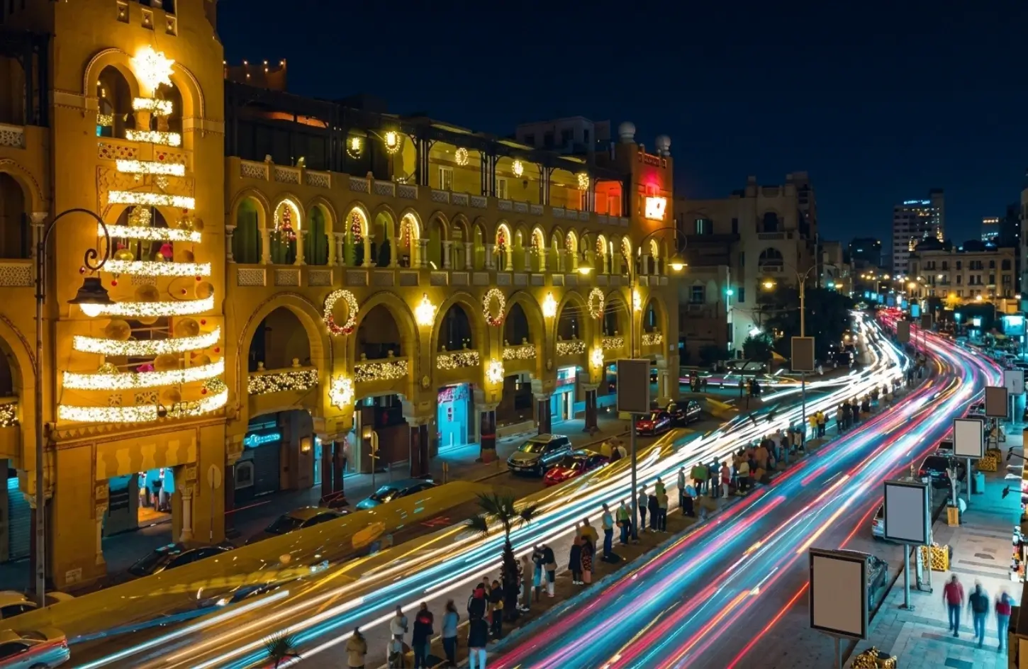 Festive Christmas light decorations on historic Egyptian architecture during night street traffic in Egypt Christmas Tours